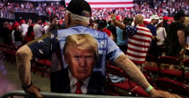 A supporter wearing a T-shirt featuring an image of former U.S. President and Republican presidential candidate Donald Trump looks on at a campaign event for Trump in Philadelphia, Pennsylvania, U.S., June 22, 2024. (Reuters Photo)