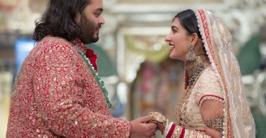 Anant Ambani (L), the son of billionaire Mukesh Ambani, holds hands with Radhika Merchant during their wedding ceremony in Mumbai, India, July 12, 2024. (AP Photo)