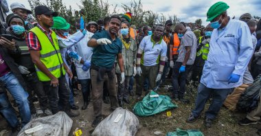 People gather around disposed bodies of victims allegedly killed by Collins Jumaisi Khalusha in the Mukuru kwa Njenga area, Nairobi, Kenya, July 13, 2024. (AA Photo)