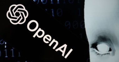 The OpenAI logo next to a robot head is seen in this illustration taken July 11, 2024. (AA Photo)