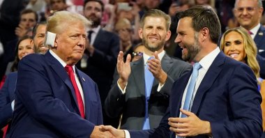 Republican presidential nominee and former U.S. President Donald Trump (L) and Republican vice presidential nominee J.D. Vance shake hands as Eric Trump watches during Day 1 of the Republican National Convention (RNC), Milwaukee, Wisconsin, U.S., July 15, 2024. (Reuters Photo)