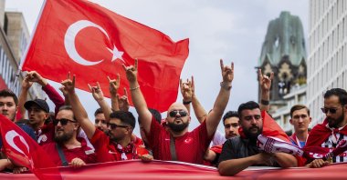 Turkish fans show the wolf sign during a fan walk before the start of the Euro 2024 match between Türkiye and Netherlands, Berlin, Germany, July 6, 2024. (AP Photo)