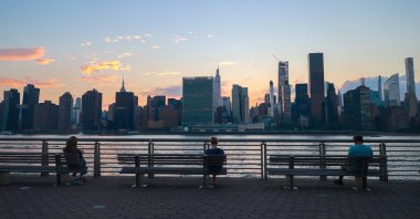 People are seen in Long Island with the Manhattan skyline in the background in New York City, New York, U.S., July 7, 2024. (AA Photo)