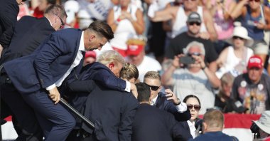 Former U.S. President Donald Trump is rushed from the stage by the Secret Service after being shot at during a campaign rally at the Butler Farm Show Inc. in Butler, Pennsylvania, U.S., July 13, 2024. (EPA Photo)