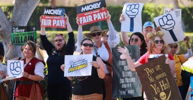 Workers gather with signs as the Teamsters union and Disney cast members demand fair wages at a rally outside Disneyland, Anaheim, California, U.S., July 17, 2024. (Reuters Photo)