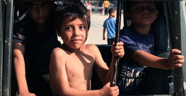 Internally displaced children play in a burnt-out vehicle in the city of Deir al-Balah, in the central Gaza Strip, Palestine, July 15, 2024. (AFP Photo)