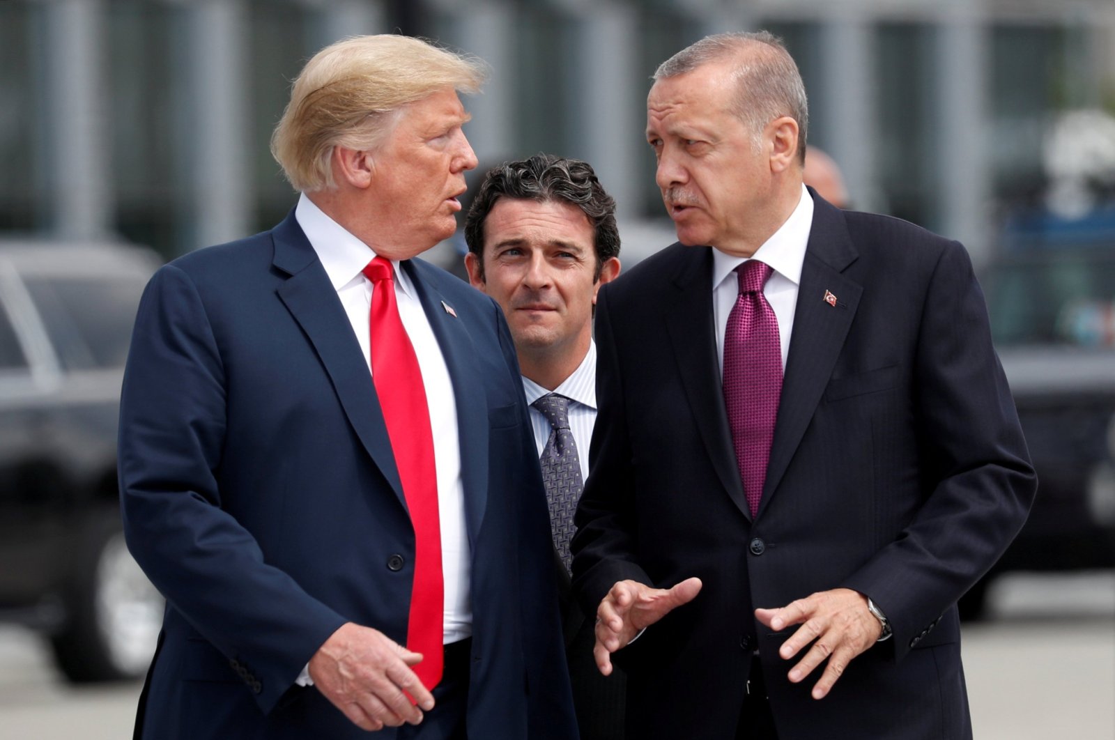 U.S. President Donald Trump and President Recep Tayyip Erdoğan gesture as they talk at the start of the NATO summit in Brussels, Belgium, July 11, 2018. (Reuters Photo)