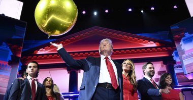 2024 Republican presidential candidate Donald Trump (C) hits a balloon during the last day of the 2024 Republican National Convention at the Fiserv Forum, Milwaukee, Wisconsin, U.S., July 18, 2024. (AFP Photo)