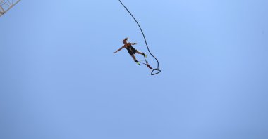 A woman is enjoying high-adrenaline moments with bungee jumping in Fethiye, Muğla, southwestern Türkiye, July 18i 2024. (AA Photo)