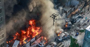 Smoke rises from the burning vehicles after protesters set them on fire near the Disaster Management Directorate office, during the ongoing anti-quota protest, Dhaka, Bangladesh, July 18, 2024. (AFP Photo)