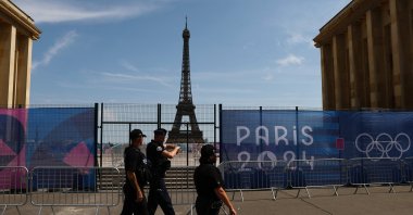 Police walk past the Eiffel Tower ahead of Paris 2024, Paris, France, July 18, 2024. (Reuters Photo)
