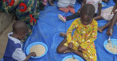 Children eat porridge prepared at a feeding center, Mudzi, Zimbabwe, July 2, 2024. (AP Photo)