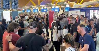 Passengers wait at Barajas Airport, as Spanish airport operator Aena on Friday reported a computer systems "incident" at all Spanish airports, which may cause flight delays, Madrid, Spain, July 19, 2024. (Reuters Photo)