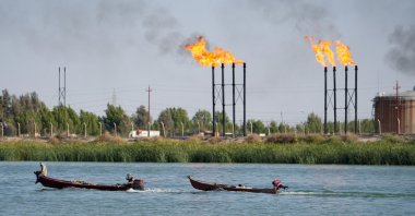 People navigate boats near the Nahr Bin Umar oil field, Basra, Iraq, June 30, 2024. (Reuters Photo)