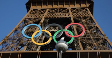 A bird is pictured as the Olympic rings are seen on the Eiffel Tower ahead of the Paris 2024 Olympic and Paralympic Games, Paris, France, July 21, 2024. (Reuters Photo)
