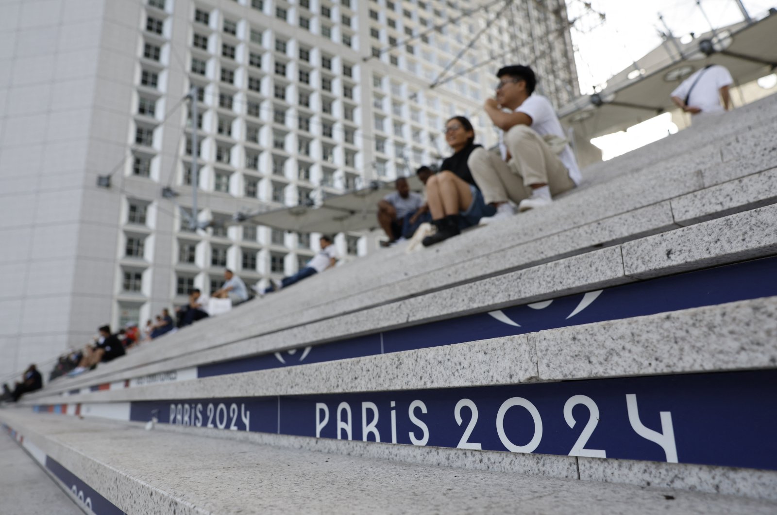 People are pictured on the steps of La Grande Arche ahead of the Paris 2024 Olympics, Paris, France, July 21, 2024. (Reuters Photo) 