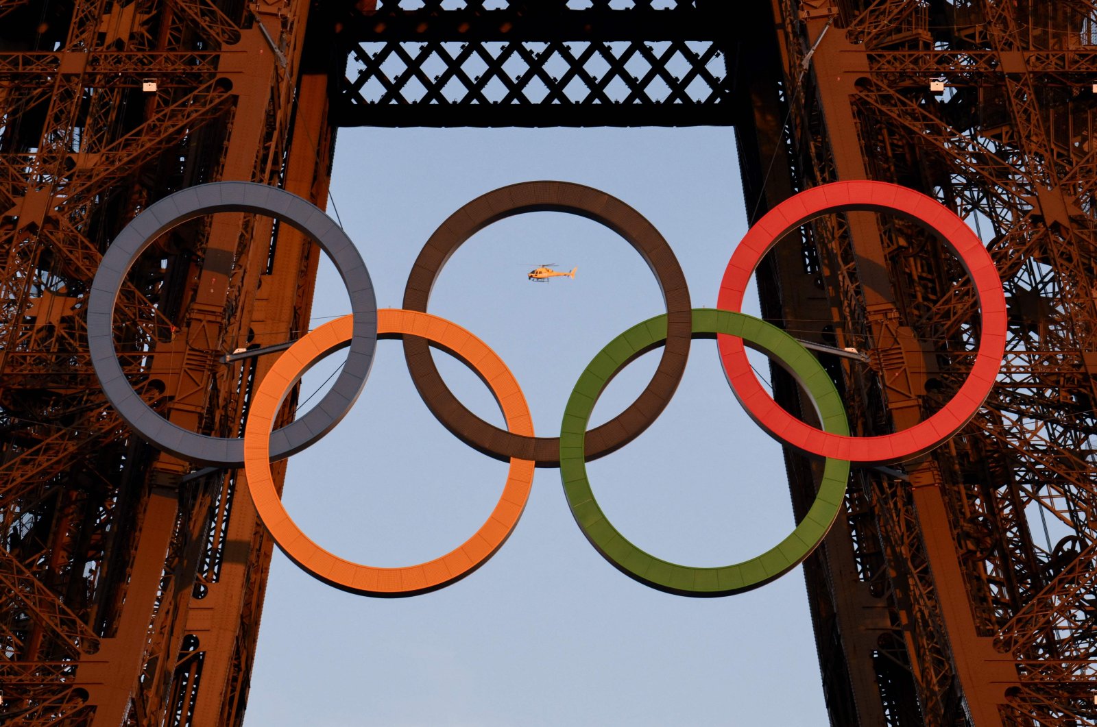 A helicopter flies around the Eiffel Tower with the Olympic rings displayed on it ahead of the Paris 2024 Olympic and Paralympic Games, Paris, France, July 21, 2024. (AFP Photo)