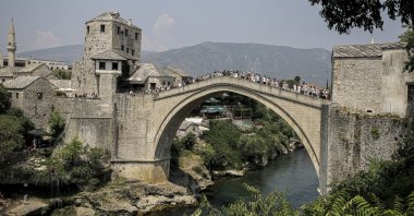 Visitors spend time on the historic Mostar Bridge on the Neretva River, southern Bosnia-Herzegovina, July 22, 2024. (AA Photo)