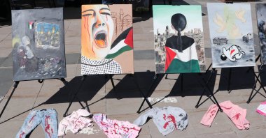 The artworks and clothes dyed in the color of blood symbolize the genocide in Gaza, Erzurum, Türkiye, July 22, 2024. (AA Photo)