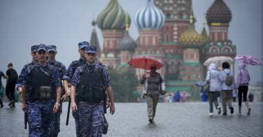 A group of Rosgvardia (National Guard) servicemen walk under the rain through Red Square in Moscow, Russia, July 22, 2024. (AP Photo)