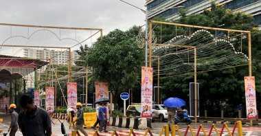 People walk past posters of Indian Prime Minister Narendra Modi outside Jio World Convention Centre, the wedding venue of Anant Ambani, son of Indian billionaire Mukesh Ambani, Mumbai, India, July 12, 2024. (Reuters Photo)