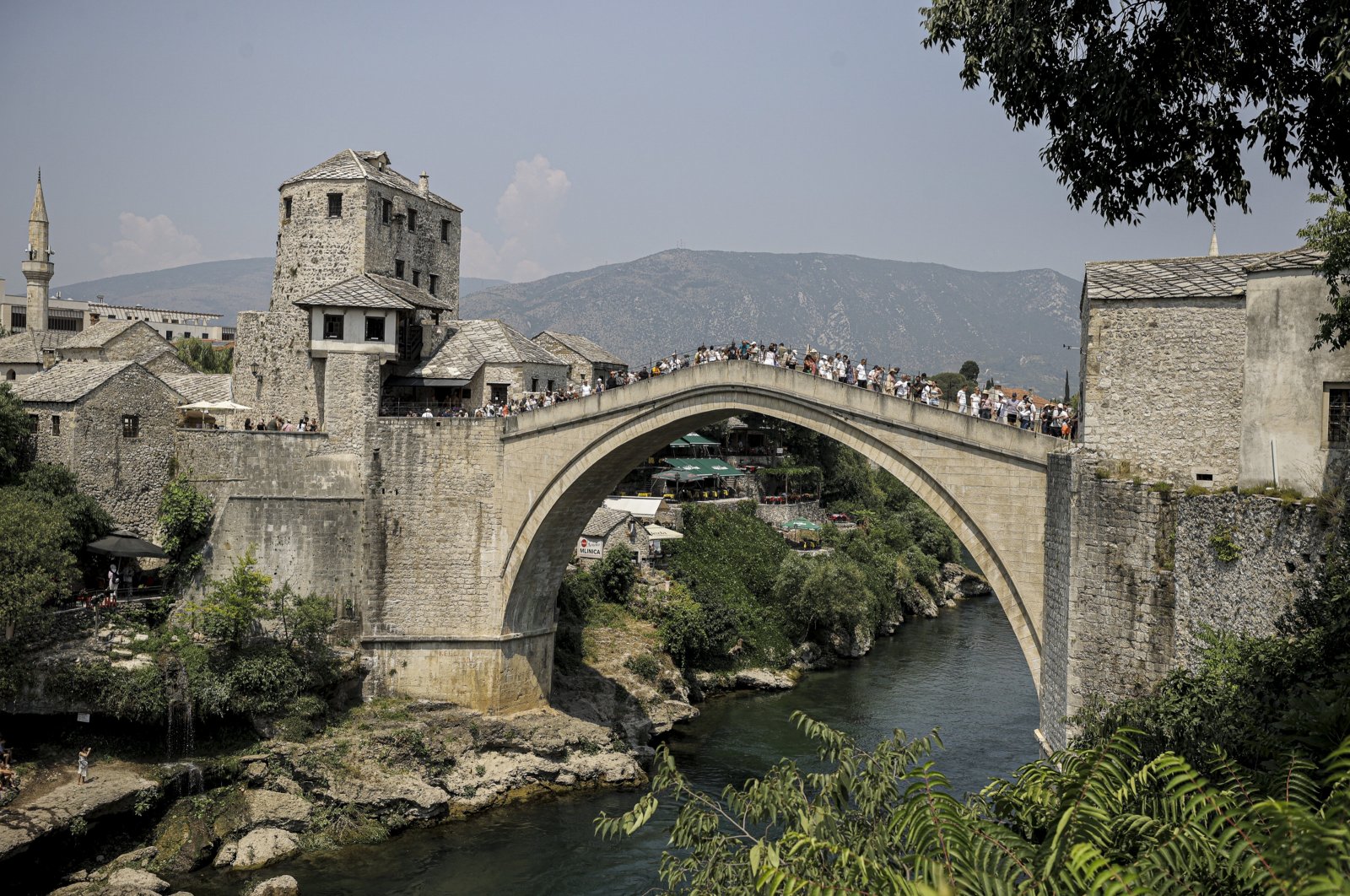 Visitors spend time on the historic Mostar Bridge on the Neretva River, southern Bosnia-Herzegovina, July 22, 2024. (AA Photo)