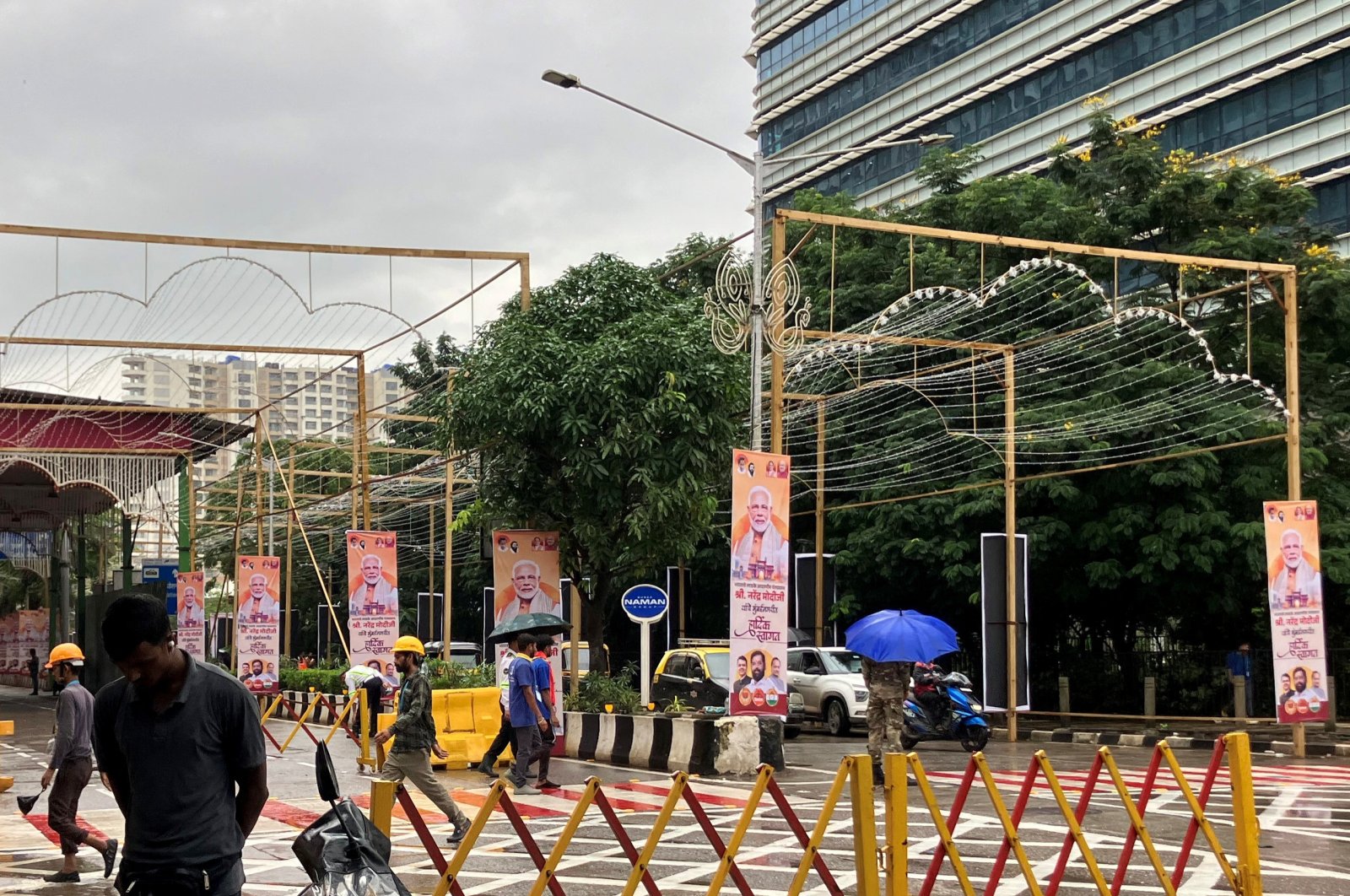 People walk past posters of Indian Prime Minister Narendra Modi outside Jio World Convention Centre, the wedding venue of Anant Ambani, son of Indian billionaire Mukesh Ambani, Mumbai, India, July 12, 2024. (Reuters Photo)