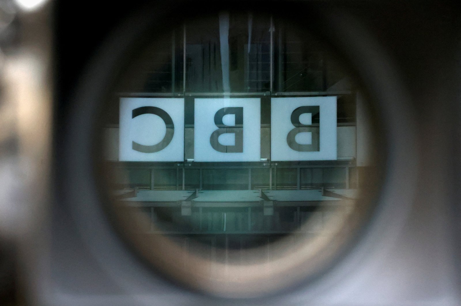 A BBC logo is reflected in the viewfinder of a television camera outside the British Broadcasting Corporation (BBC) headquarters, London, U.K., March 13, 2023. (Reuters Photo)