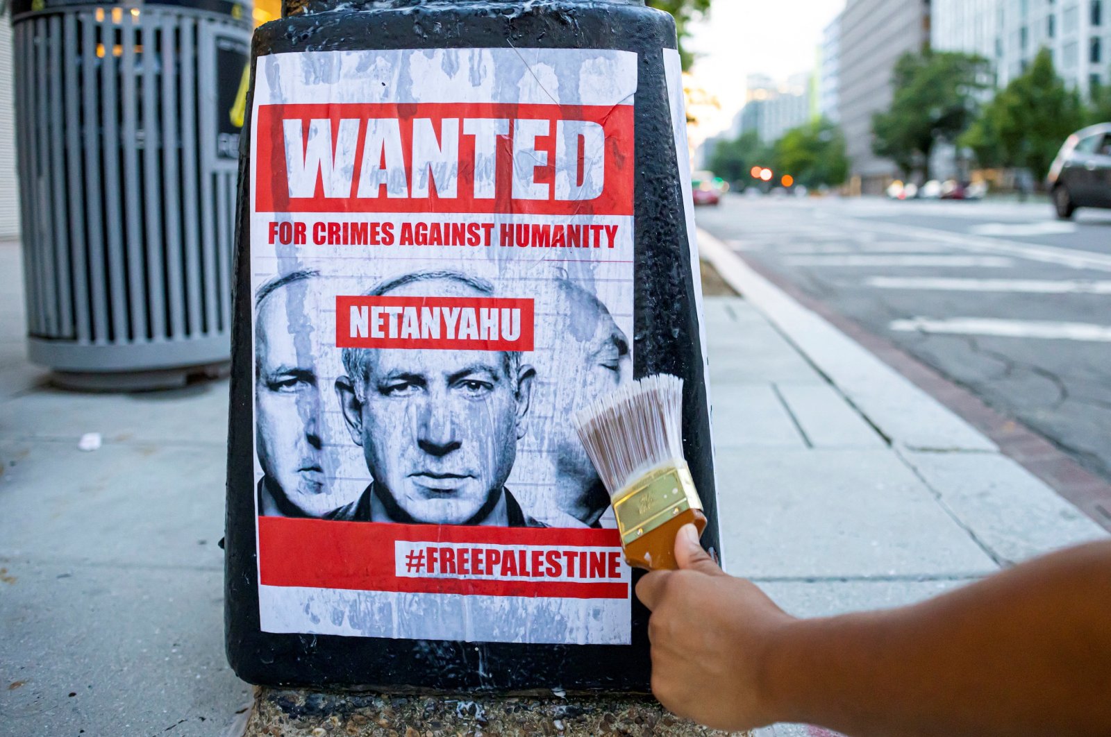 An activist pastes a sign to the base of a lamppost protesting against the upcoming visit of Israeli Prime Minister Benjamin Netanyahu and his address to a joint meeting of Congress in Washington, U.S., July 21, 2024. (Reuters Photo)