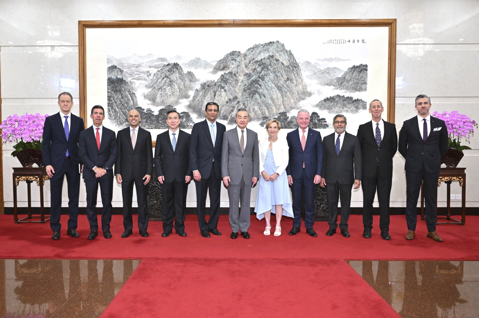 In this photo released by Xinhua News Agency, Chinese Foreign Minister Wang Yi (6th L) poses for a photo with a United States business delegation including FedEx CEO Raj Subramaniam (5th L) and Chindex CEO Roberta Lipson (5th R), Beijing, China, July 22, 2024. (AP Photo)