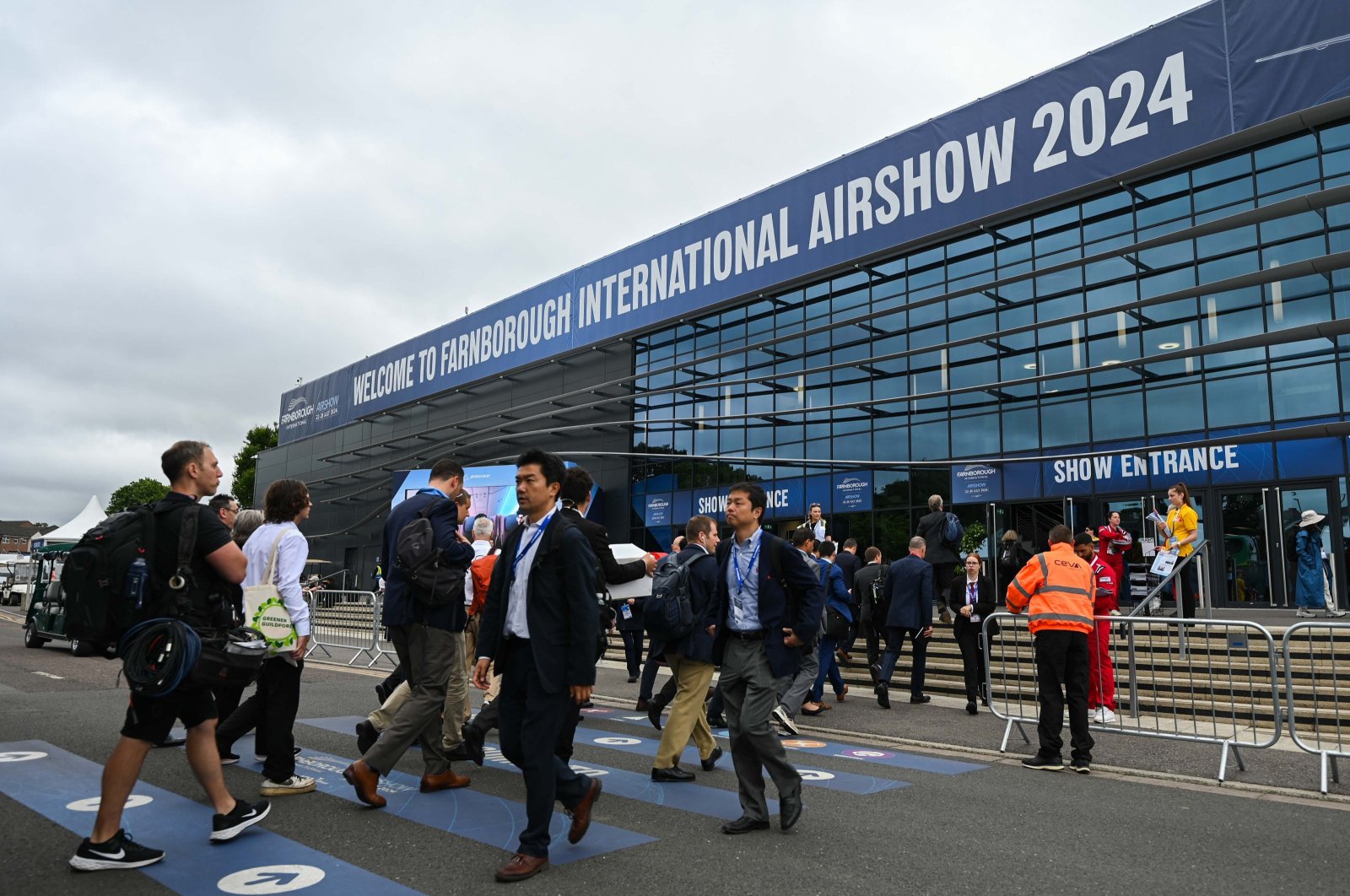 People are photographed at the entrance to Farnborough International Airshow, Farnborough, U.K., July 23, 2024. (AA Photo)