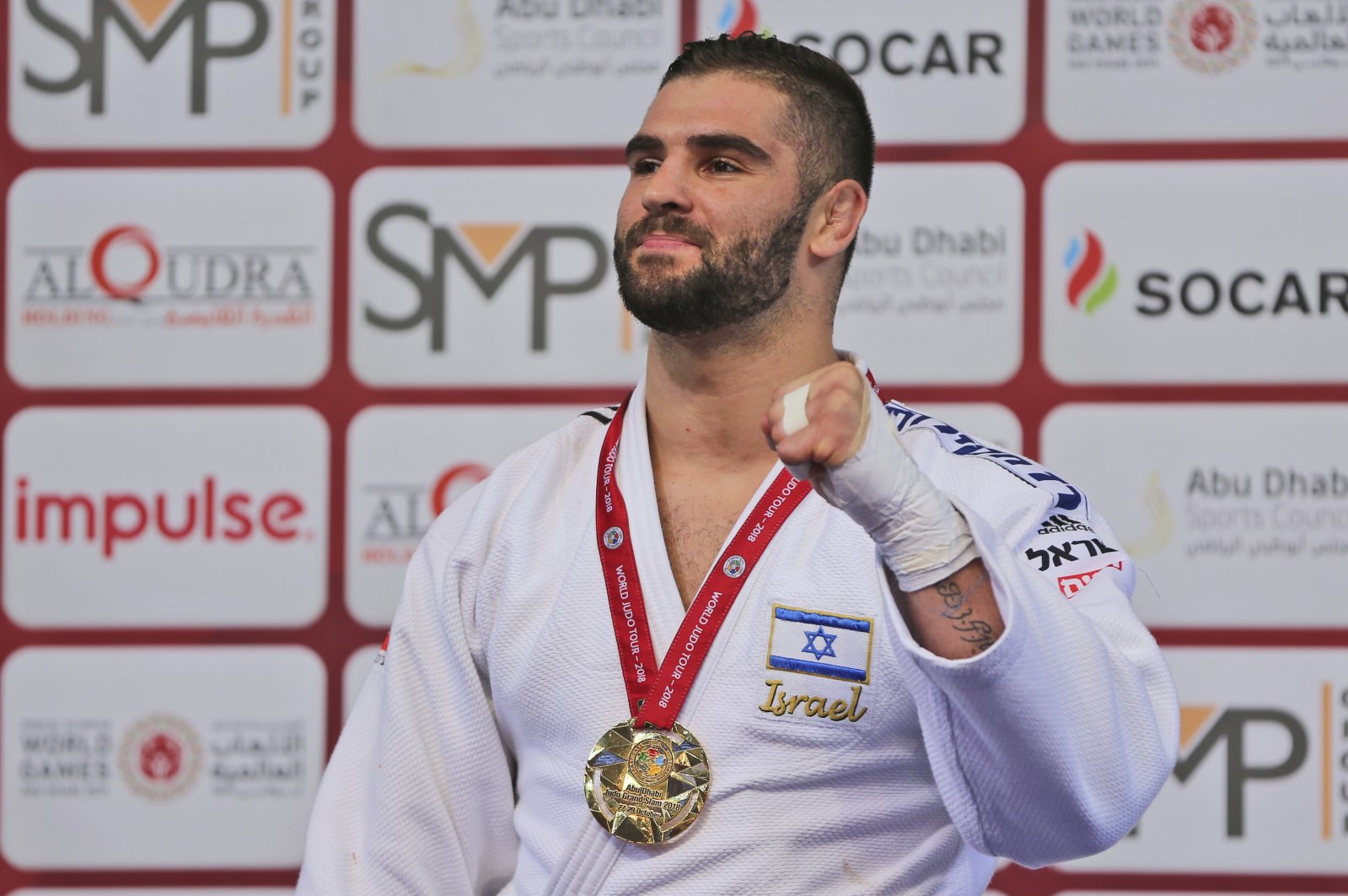 Israel&#039;s Peter Paltchik poses with his gold medal during the Abu Dhabi Grand Slam Judo tournament in Abu Dhabi, UAE, Oct. 29, 2018. (AP Photo)