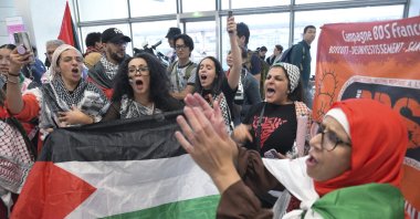 A passionate crowd of Palestinian supporters and members of the national and international press receive Palestinian athletes at the Paris Charles de Gaulle Airport, Paris, France, July 25, 2024. (AA Photo)