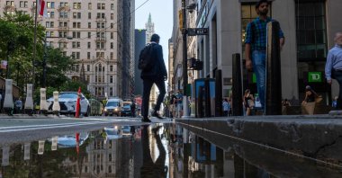 People walk through the financial district near the New York Stock Exchange (NYSE), New York, U.S., July 11, 2024. (AFP Photo)