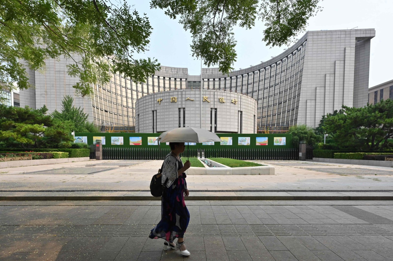 A woman walks past the headquarters of the People’s Bank of China (PBOC), the country’s central bank, Beijing, China, July 9, 2024. (AFP Photo)