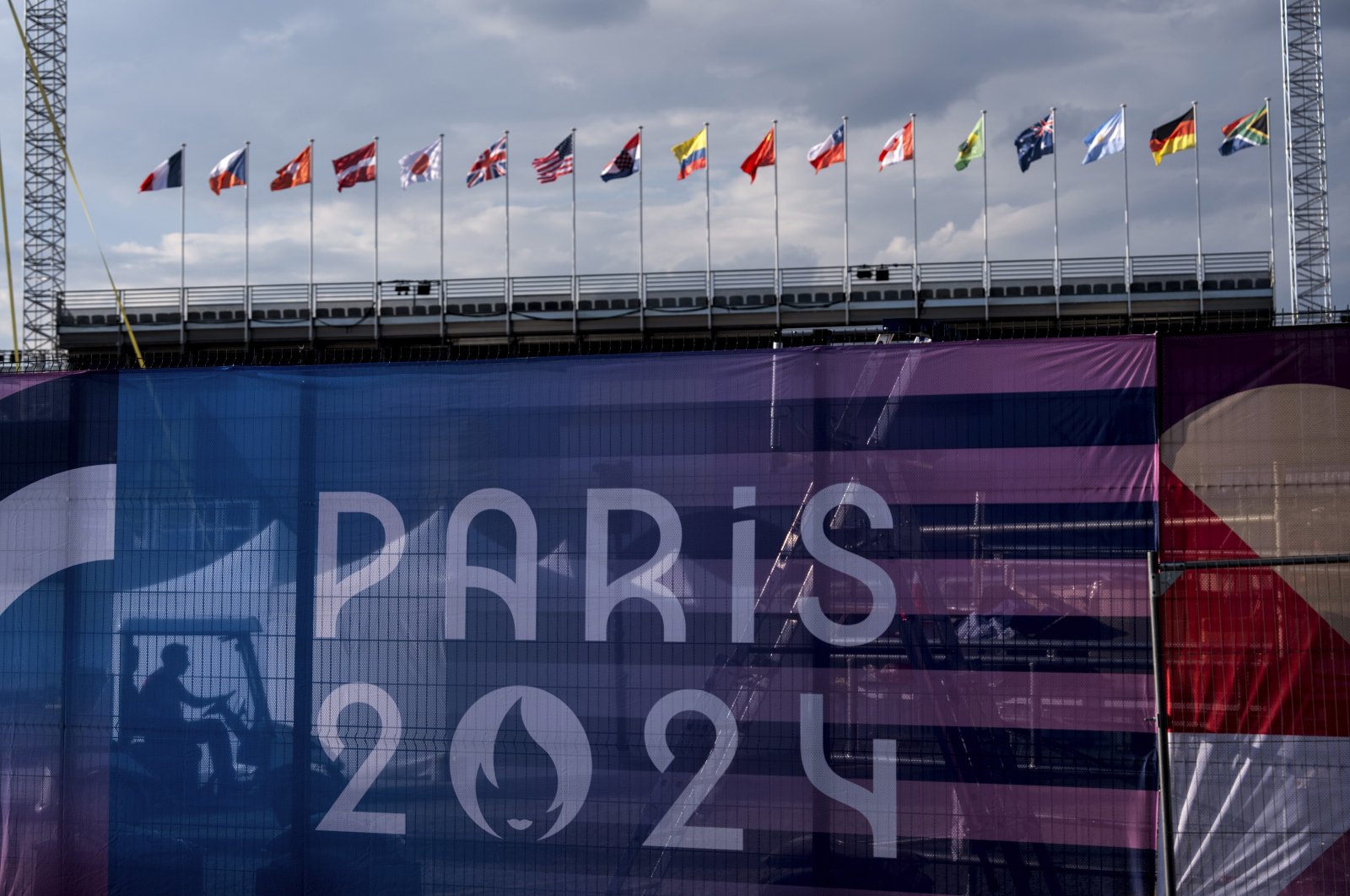 A worker drives a golf cart inside the competition venue for BMX freestyle ahead of the 2024 Summer Olympics, Paris, France, July 19, 2024. (AP Photo)