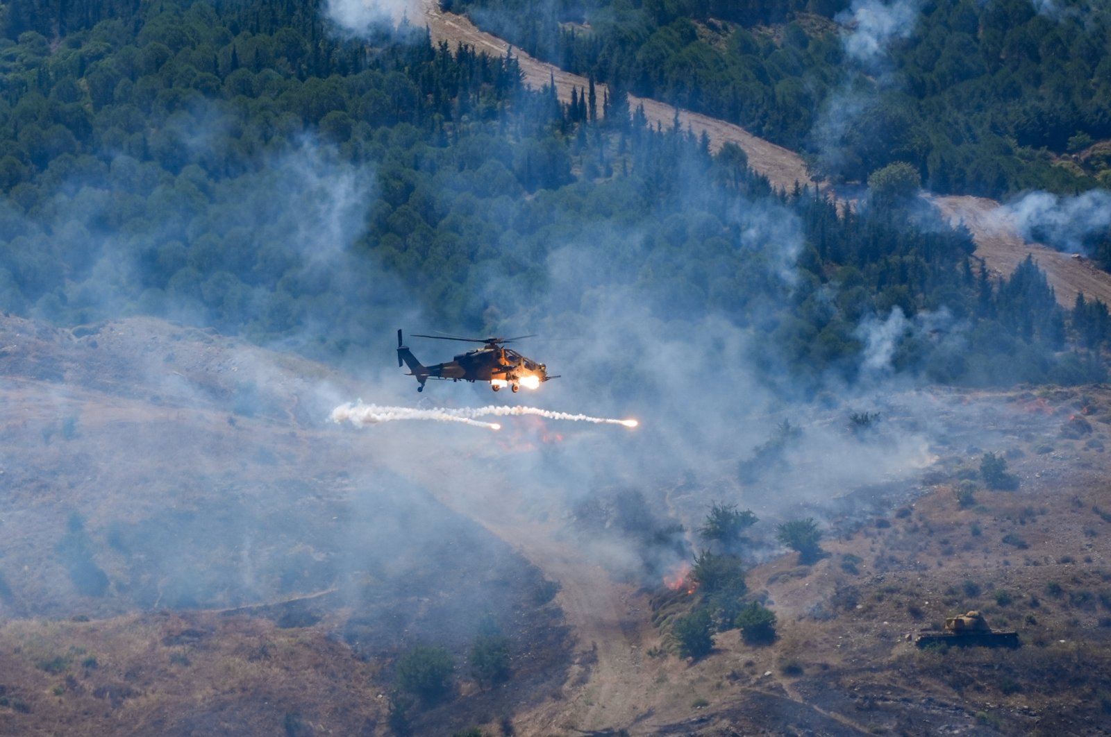 An attack helicopter conducts targets practice during military exercise Efes-2024 in western Izmir province, Türkiye, May 30, 2024. (AA Photo)