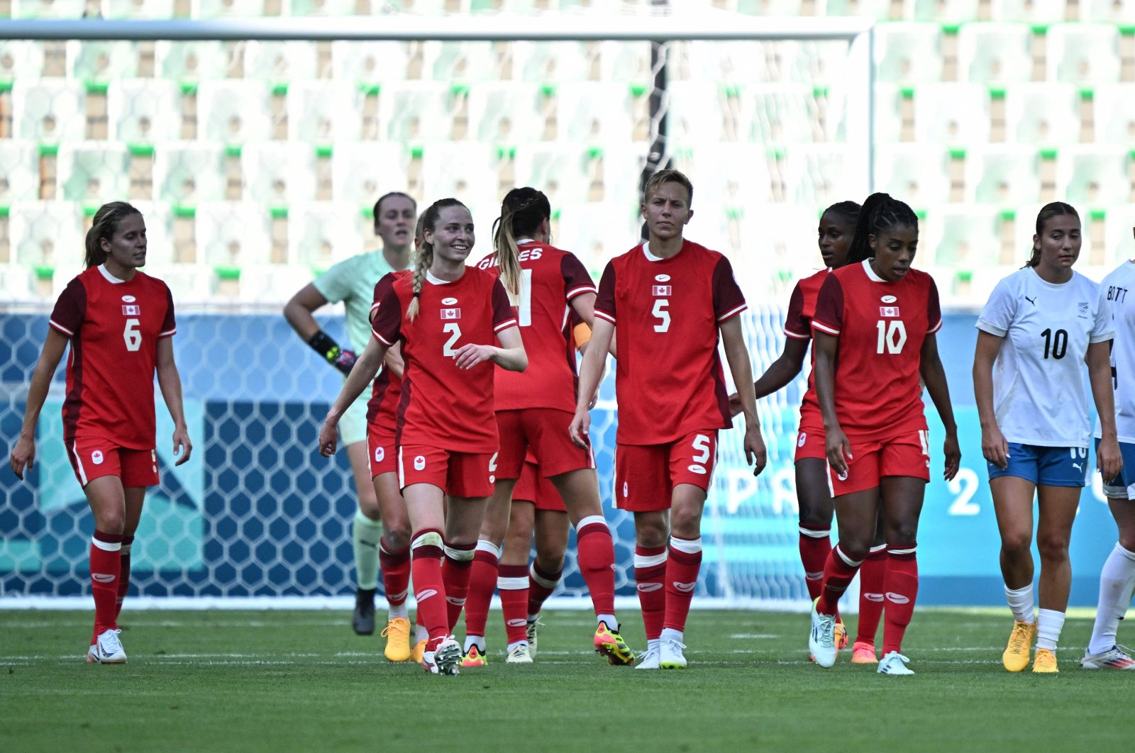 Canada&#039;s forward #06 Cloe Lacasse celebrates with teammates after scoring her team&#039;s first goal in the women&#039;s group A football match between Canada and New Zealand during the Paris 2024 Olympic Games at the Geoffroy-Guichard Stadium in Saint-Etienne on July 25, 2024. (AFP Photo)