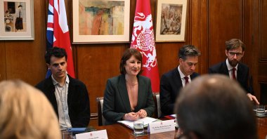 Britain's Chancellor of the Exchequer Rachel Reeves (C) sits between her special adviser Neil Amin-Smith (L) after Britain's Climate Change and Net Zero Secretary Ed Miliband (2nd R) during a meeting of the National Wealth Fund Taskforce at 11 Downing Street, London, U.K., July 9, 2024. (AFP Photo)