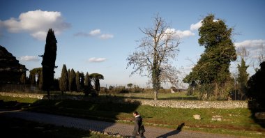 A man walks on the old Appian Way, near the area where a life-sized statue of a Roman emperor posing as the classical hero Hercules was discovered during sewer repair works in Rome, Italy, Feb. 1, 2023. (Reuters Photo)