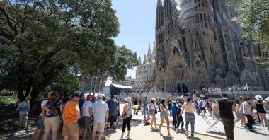 Tourists walk past the Sagrada Familia basilica in Barcelona, Spain, July 5, 2024. (AFP Photo)