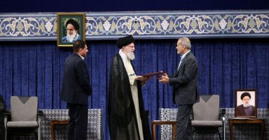 Iranian Supreme Leader Ayatollah Ali Khamenei (C) presenting the official endorsement letter to President-elect Masoud Pezeshikan (R) in Tehran, Iran, July 28, 2024. (EPA Photo)