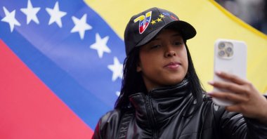 A Venezuelan expat takes a picture during the country&#039;s presidential election, at a voting station in Bogota, Colombia, July 28, 2024. (Reuters Photo)