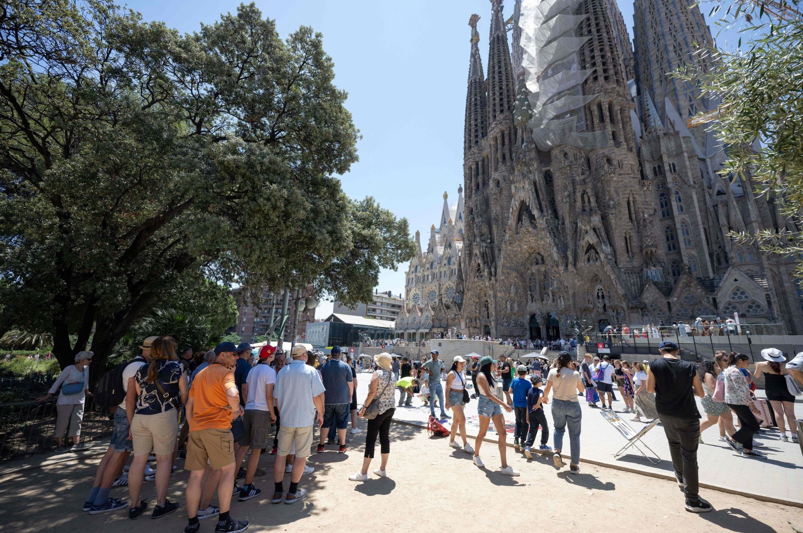 Tourists walk past the Sagrada Familia basilica in Barcelona, Spain, July 5, 2024. (AFP Photo)