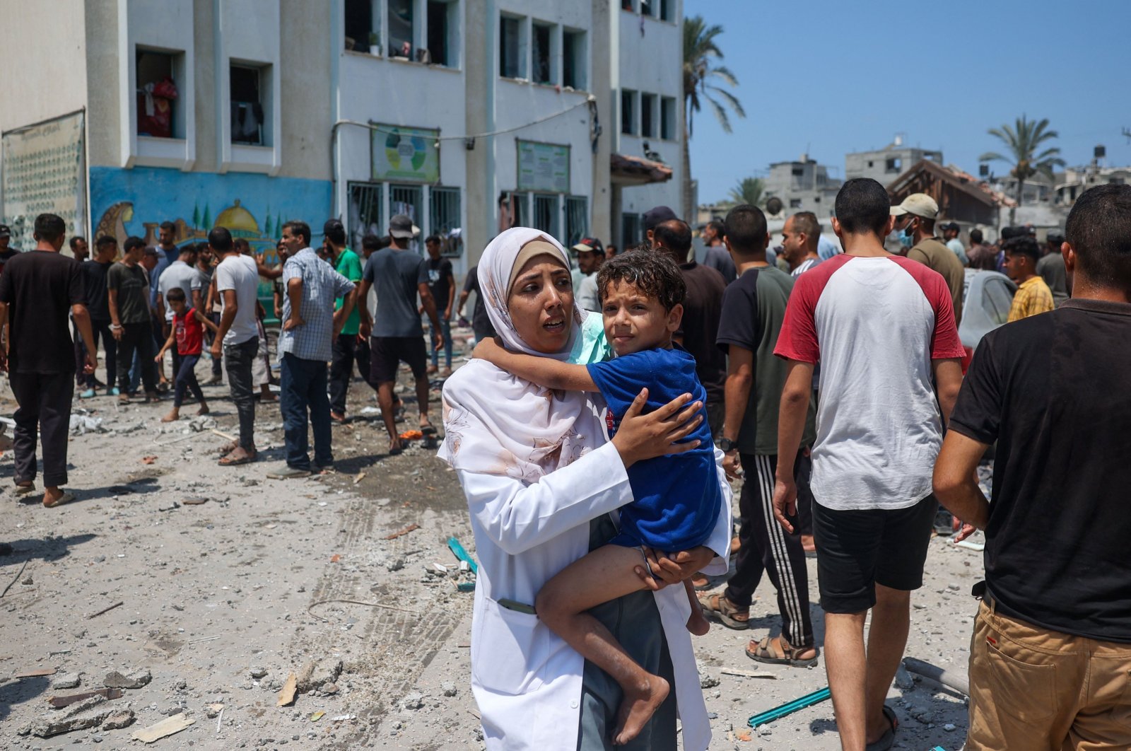 Palestinians flee Khadija school housing displaced people after an Israeli strike, in Deir al-Balah, in the central Gaza Strip, Palestine, July 27, 2024. (AFP Photo)