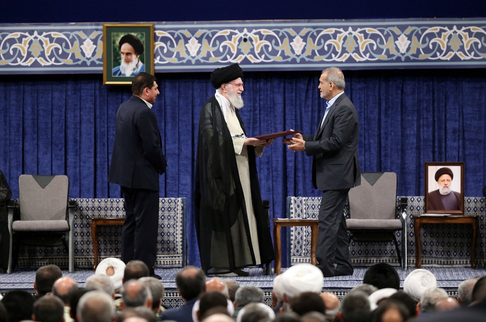 Iranian Supreme Leader Ayatollah Ali Khamenei (C) presenting the official endorsement letter to President-elect Masoud Pezeshikan (R) in Tehran, Iran, July 28, 2024. (EPA Photo)