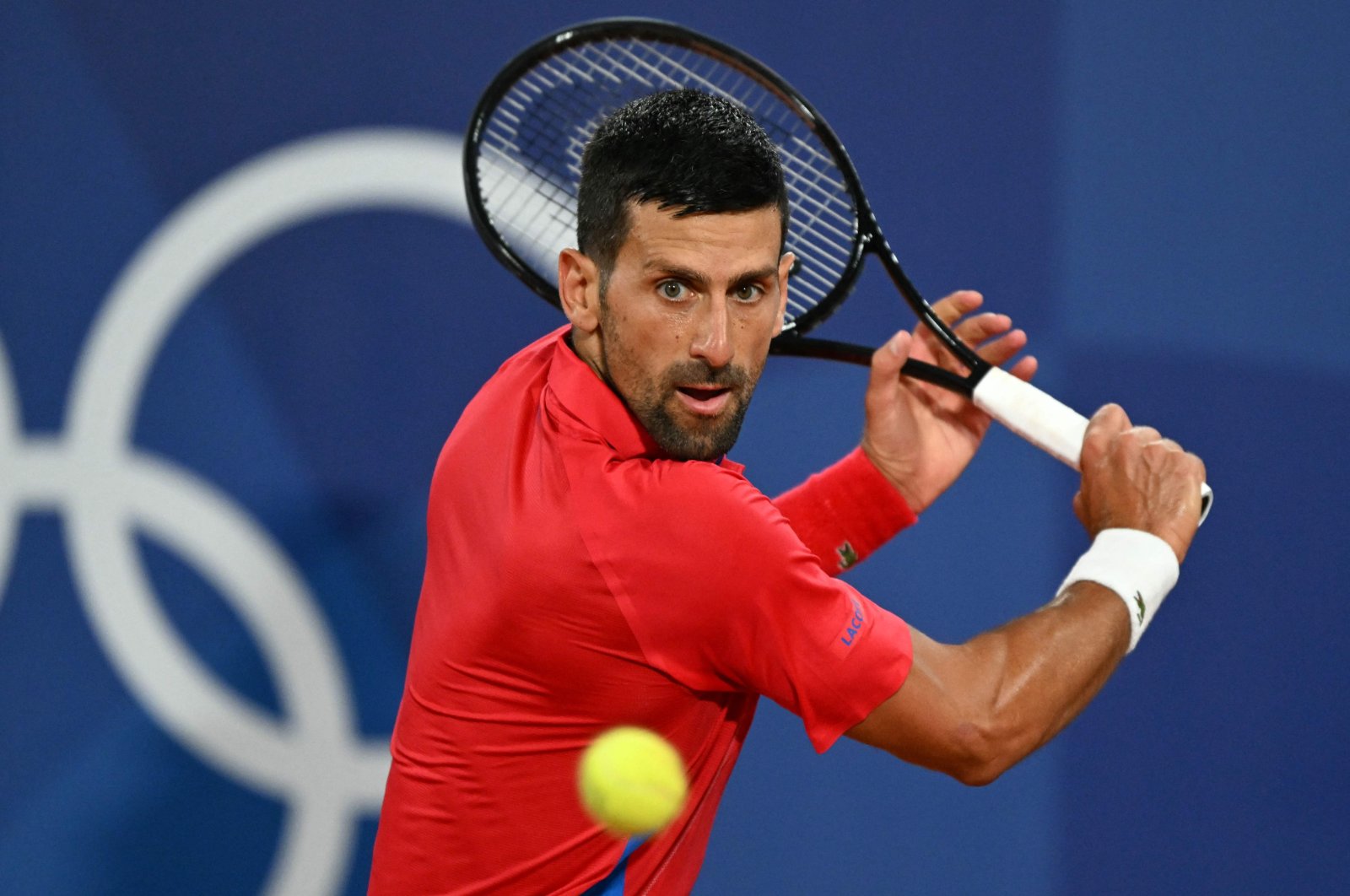 Serbia&#039;s Novak Djokovic returns to Australia&#039;s Matthew Ebden during their men&#039;s singles first round tennis match on Court Philippe-Chatrier at the Roland-Garros Stadium at the Paris 2024 Olympic Games, Paris, France, July 27, 2024. (AFP Photo)