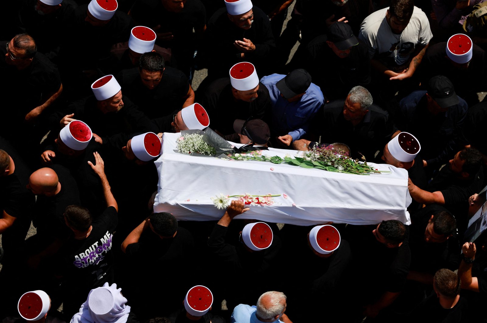 People carry a coffin, during the funeral of people killed in Majdal Shams, Israeli-occupied Golan Heights, July 28, 2024. (Reuters Photo)