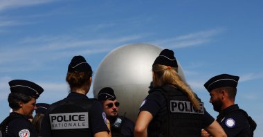 Police officers are seen near the Olympic cauldron during the Olympics, Paris, France, July 28, 2024. (Reuters Photo) 