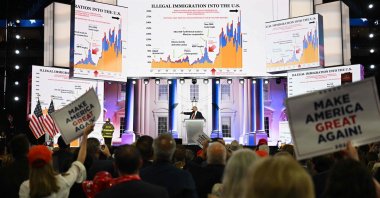 Former U.S. president and 2024 Republican presidential candidate Donald Trump speaks in front of screens showing charts on immigration during the last day of the 2024 Republican National Convention, Milwaukee, Wisconsin, U.S., July 18, 2024. (AFP Photo)
